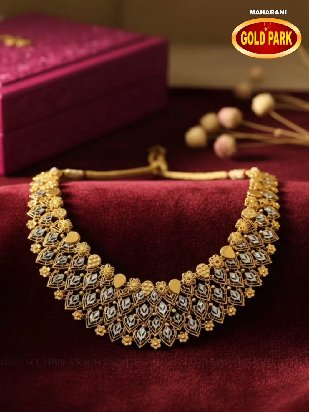 Gold bridal necklace on maroon velvet