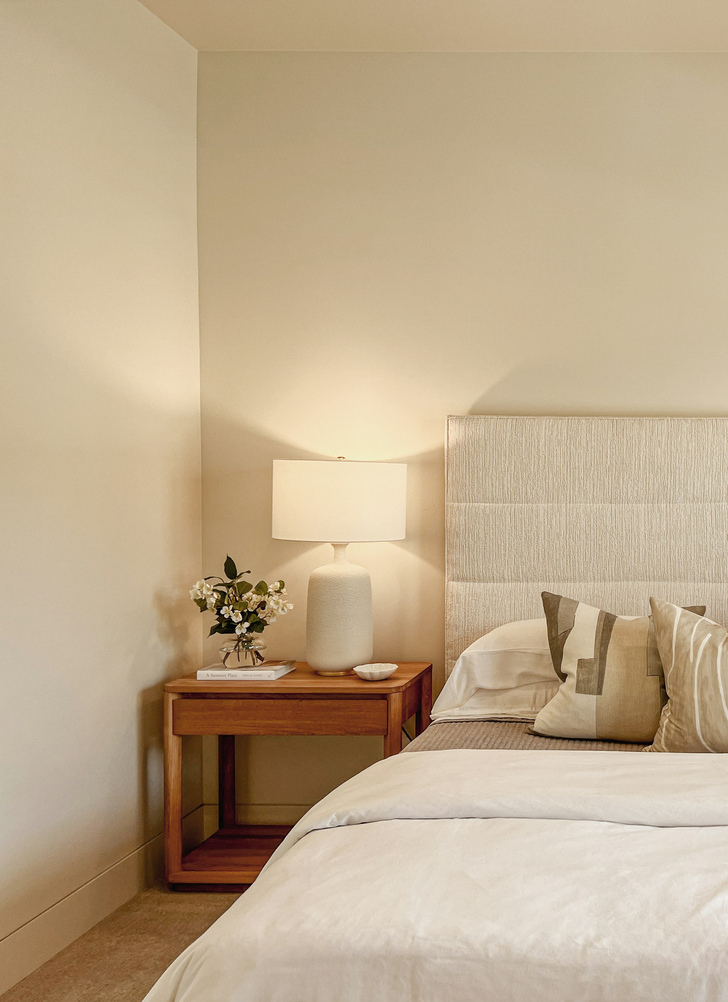 Bedroom in lamplight, linen and timber
